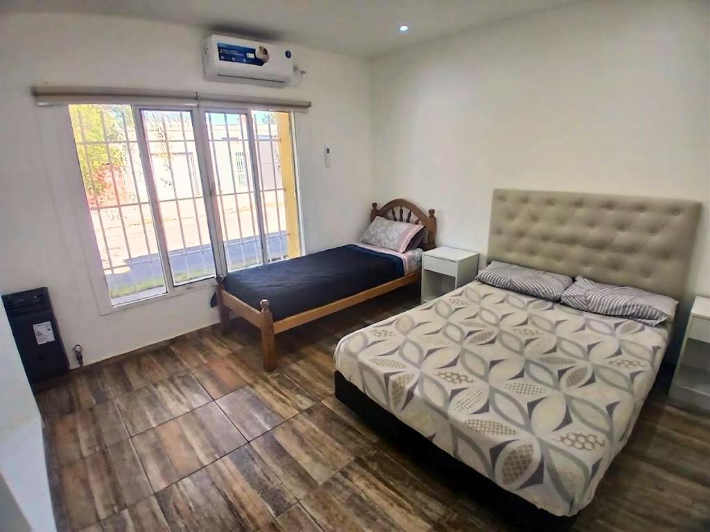 a bedroom with a bed and a window at Depto Manzur in Villa Mercedes