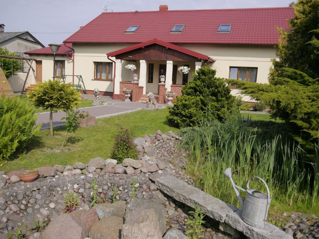 a house with a rock garden in front of it at Dworek in Swarzewo