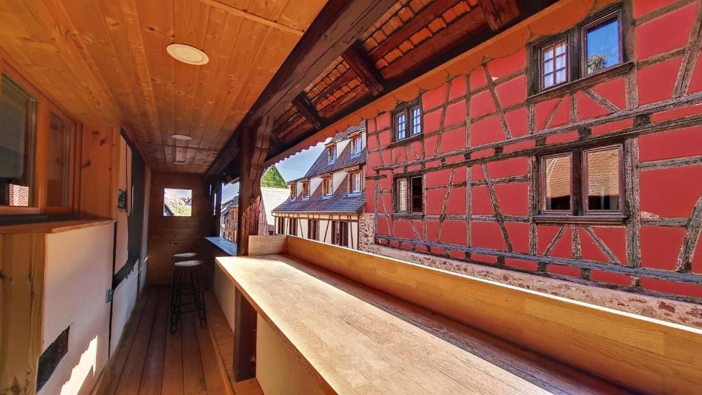 an empty hallway of an old building with a bench at Le Nature in Eguisheim