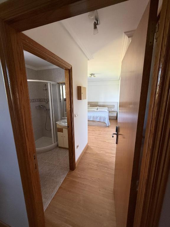 a view of a bedroom with a bed and a bathroom at Izarra Urdaneta in Aizarna