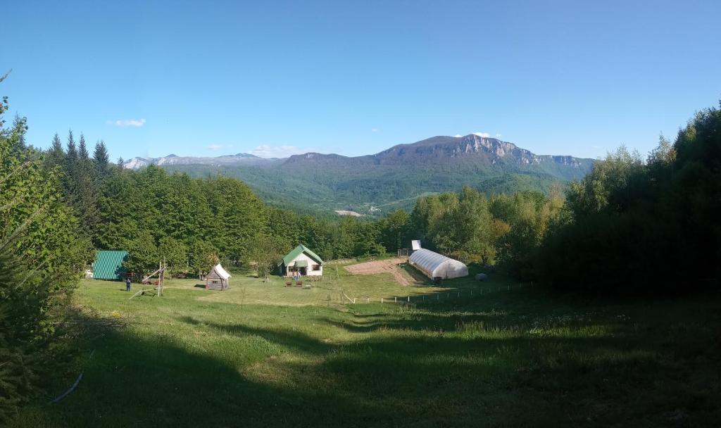 an aerial view of a farm with mountains in the background at Mountain house"LISIN"Bradina Konjic in Konjic