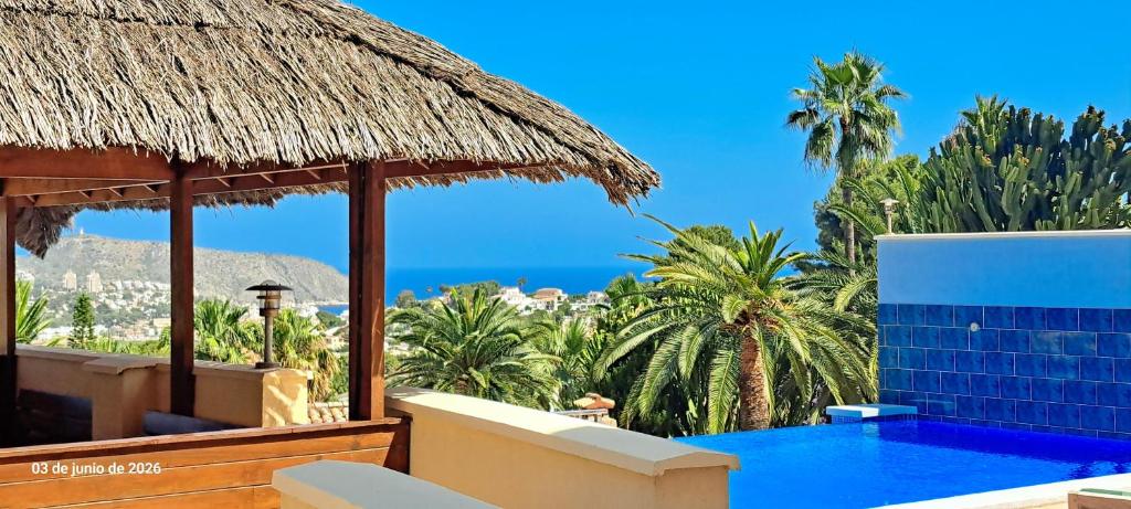 a resort with a swimming pool and a view of the ocean at Villa Evora in Moraira