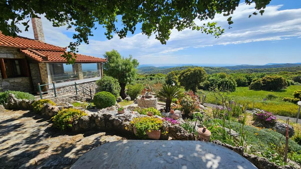 a garden in front of a house with flowers at Mountain Escape Villa in Gamvriá
