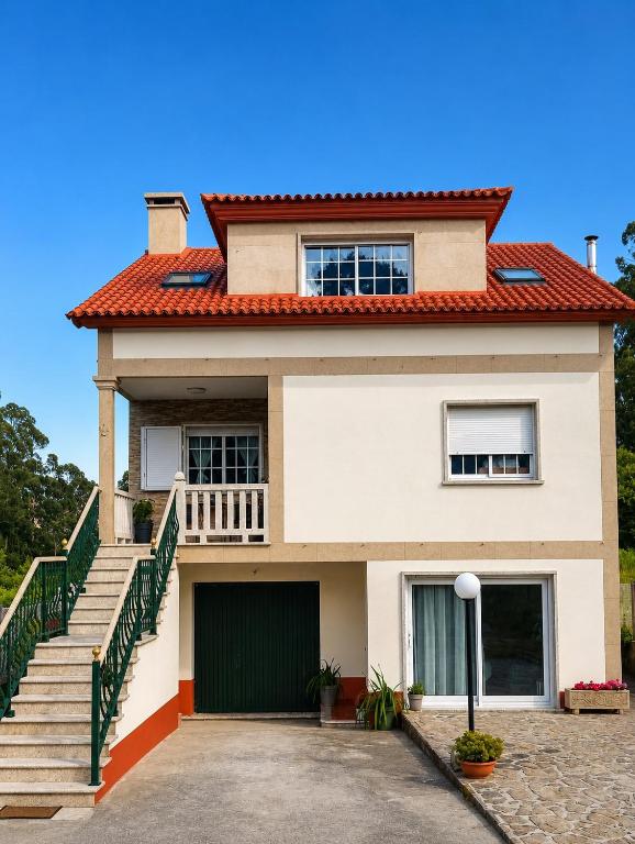 a white house with a staircase and a roof at Villa Merchy Combarro in Poio