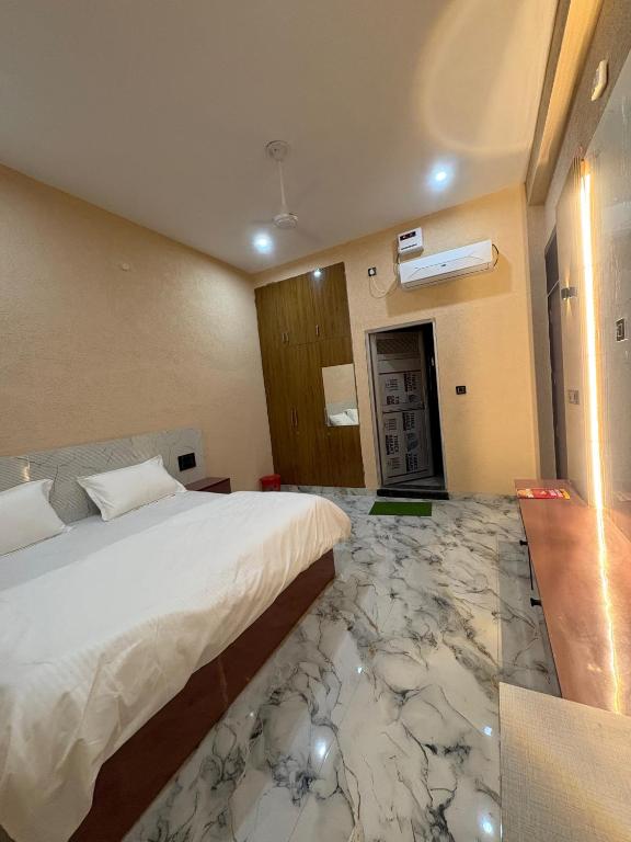 a hotel room with a bed and a marble floor at Hotel Keshav Palace in Mahwah