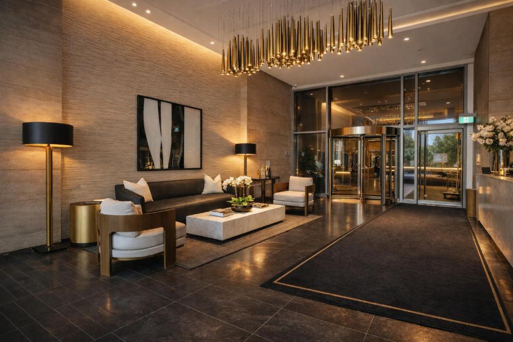 a living room with a couch and a table at The Nobleton Suites - Yorkville in Toronto