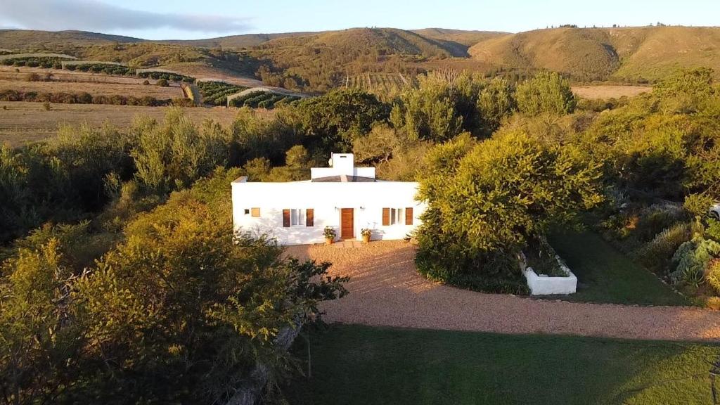 an aerial view of a white house in a field at Jonkershuis Farm Retreat in Heidelberg