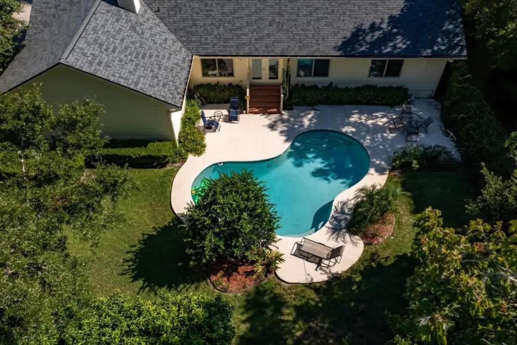 an overhead view of a swimming pool in front of a house at Coastal Lane - Entire in Jacksonville