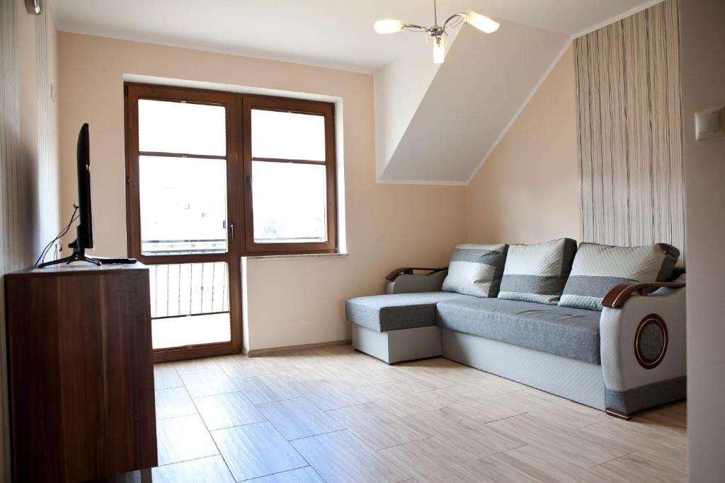 Televízia a/alebo spoločenská miestnosť v ubytovaní Apartamenty by Hanna