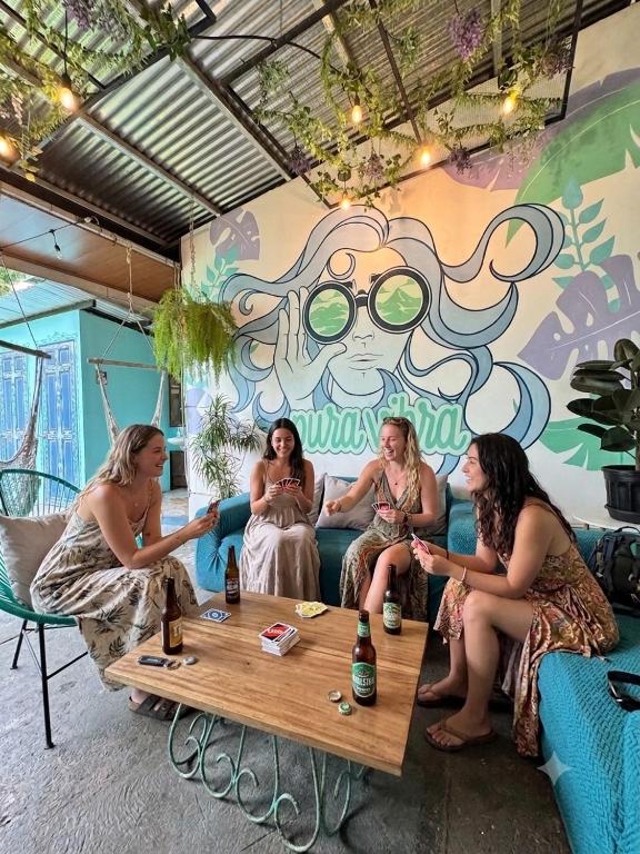 a group of women sitting on a couch in a room at Pura Vibra Hostel in Fortuna