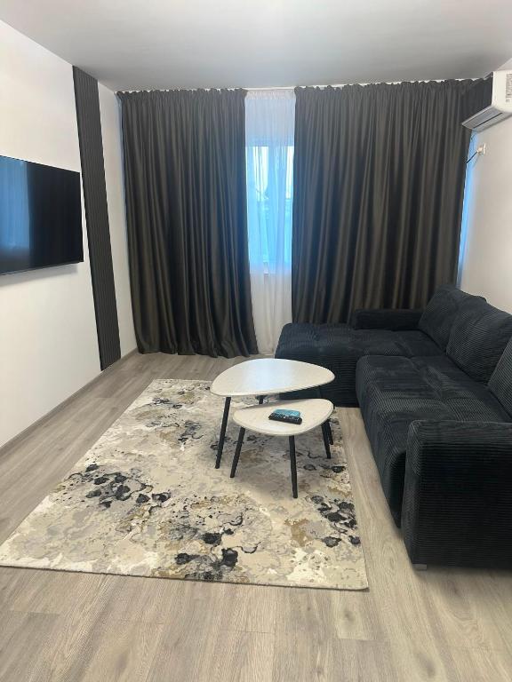 a living room with a couch and a table at Nova Residence Craiova in Craiova