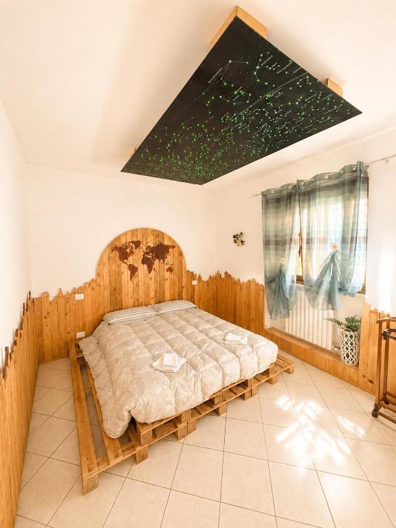 a bedroom with a bed with a wooden frame at Casa Campomonte in Poppi