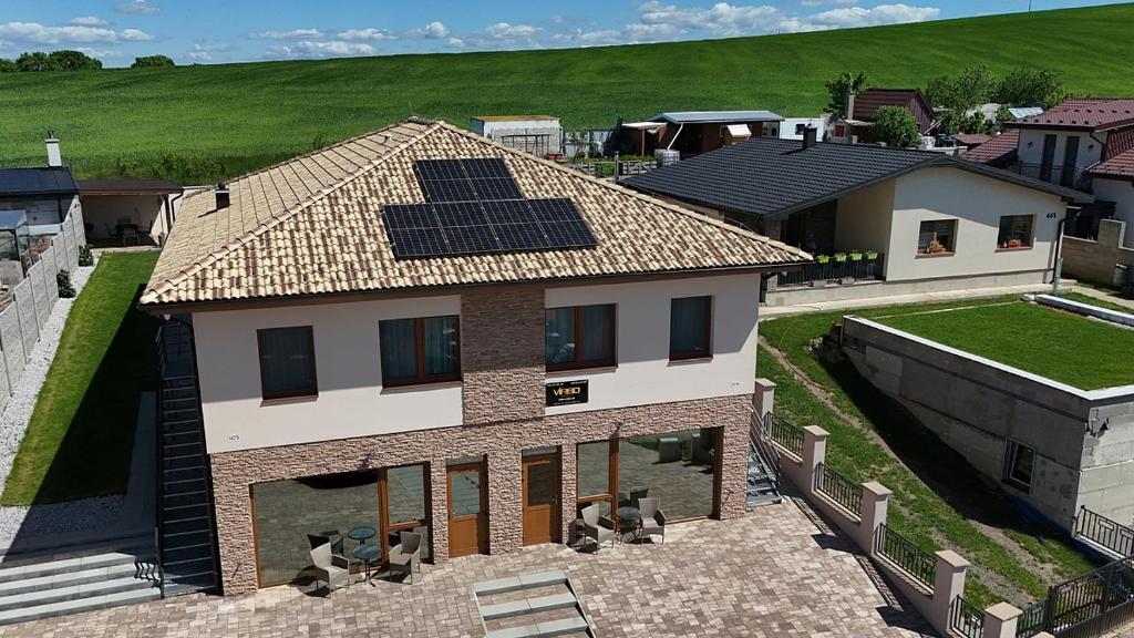 a house with solar panels on the roof at Apartmány Virbo in Vrbov