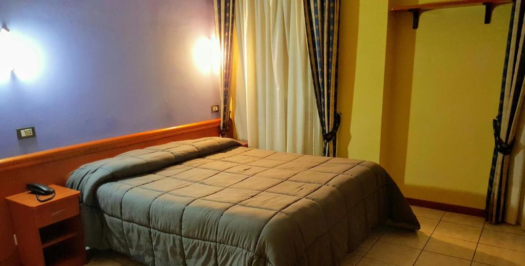 Posteľ alebo postele v izbe v ubytovaní Hotel Ristorante Umbria