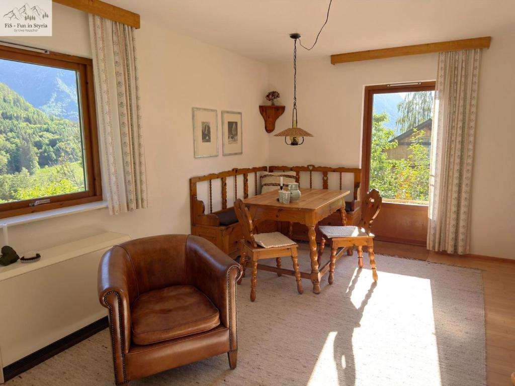 a dining room with a table and chairs and a window at Ferienhaus Kleinod in Bad Aussee
