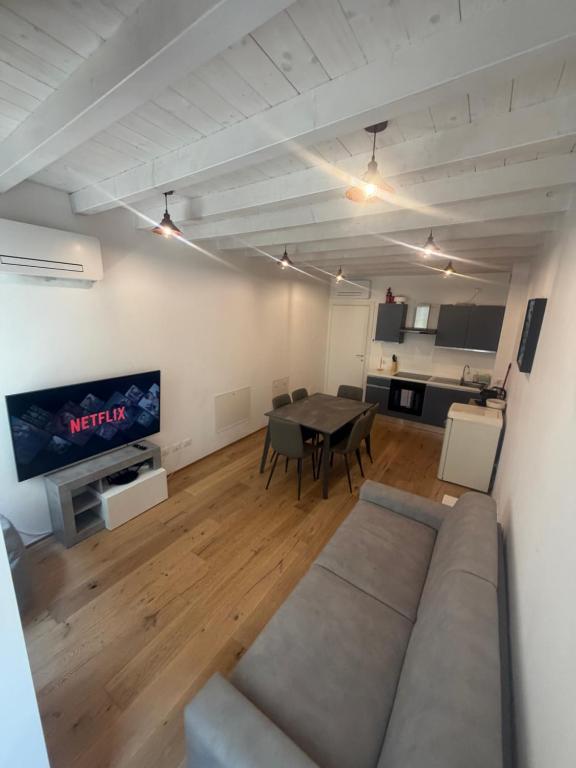 a living room with a couch and a table at Vittoria Tre Piazze Apartments in Brescia