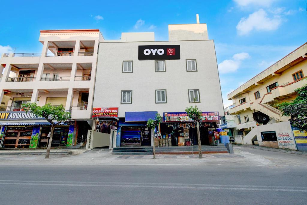 a white building with an xo sign on it at Super HOTEL O GOLDEN CITY INN in Maula Ali