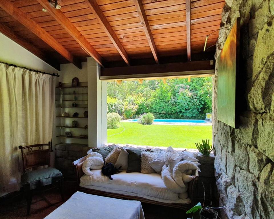 a couch in a room with a large window at Un Espacio de Buscadores in Ingeniero Maschwitz