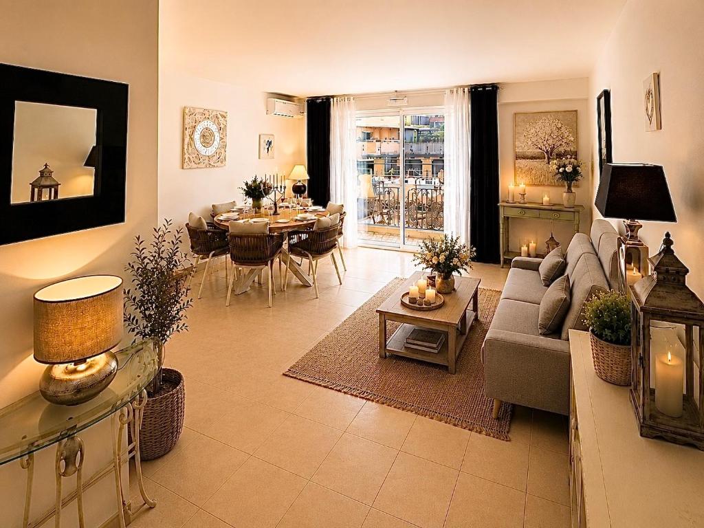 a living room with a couch and a table at Le Aix Rotonde Mirabeau - Centre Ville Terrasse Garage in Aix-en-Provence
