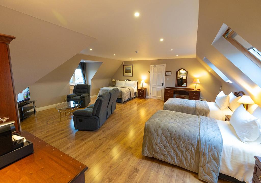 a bedroom with two beds and a living room at The Tides Ballybunion in Ballybunion