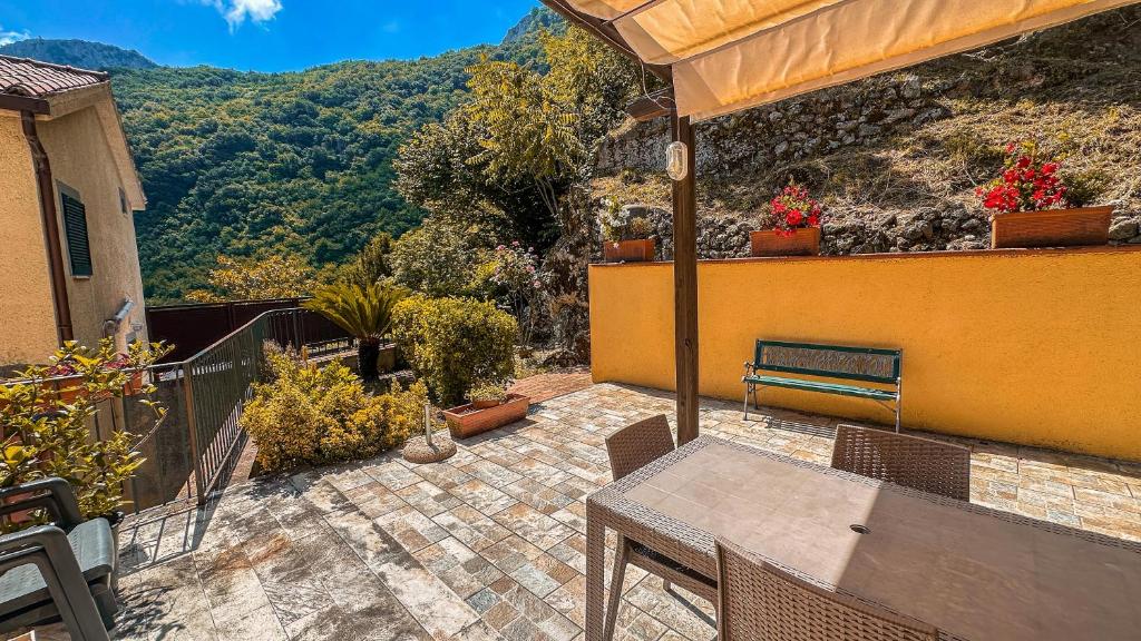 a patio with a table and chairs on a balcony at Casa Santicelli Maratea ' I CARPINI ' in Maratea