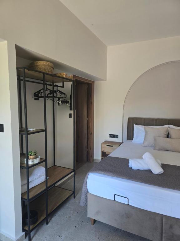 a bedroom with a bed and a book shelf at Eden's Garden luxury Studio in Kalamitsi