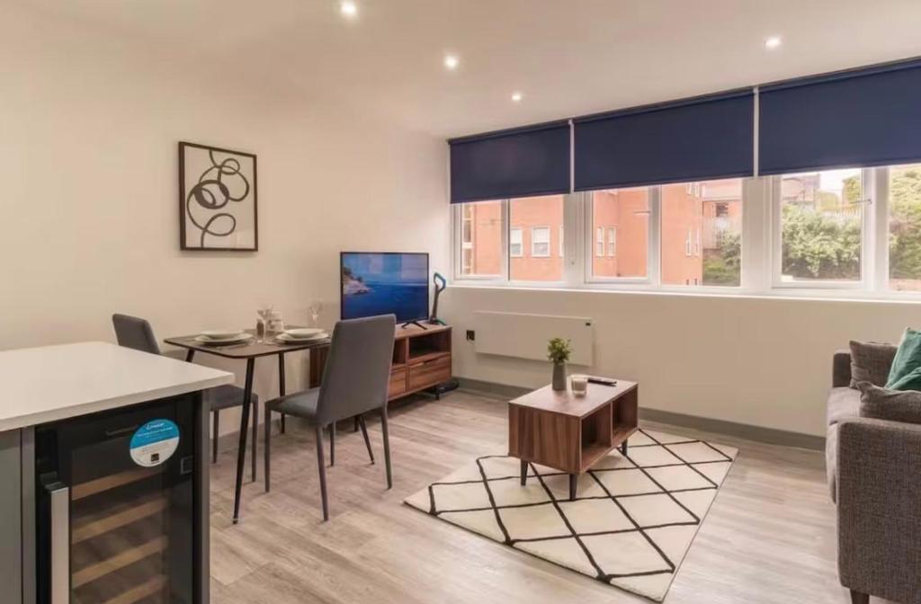 a living room with a table and a couch at Comfortable 1 Bed Apartment Town Centre in Preston