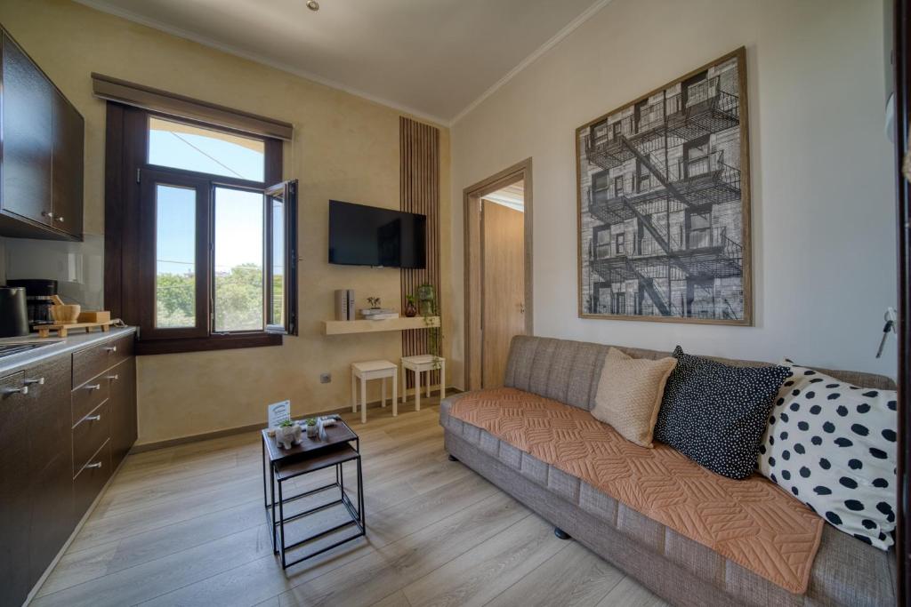 a living room with a couch and a table at Lotza apartment Votsalo in Vrontádos