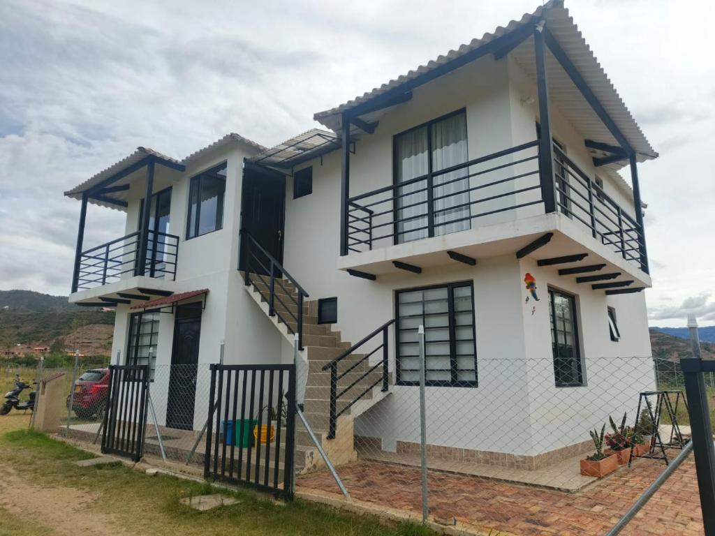 a house with a fence in front of it at El Eden in Sáchica