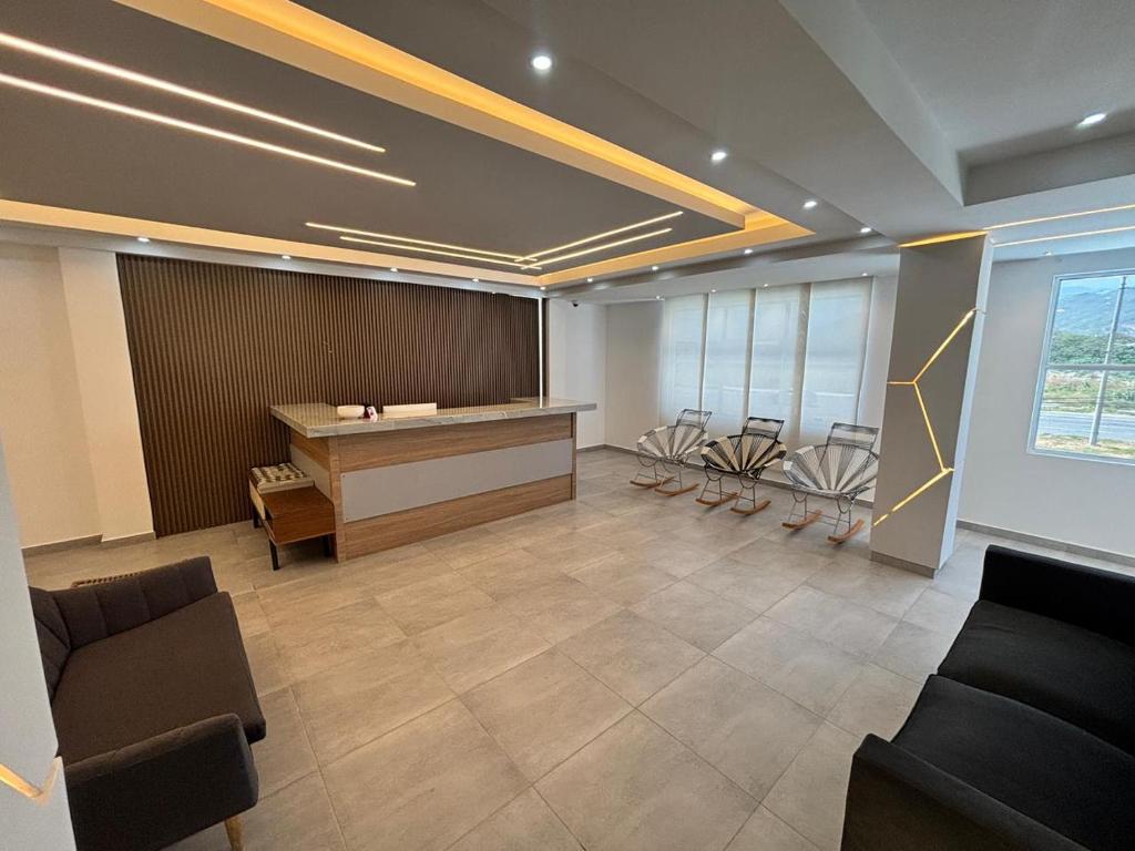 a lobby with a desk and chairs in a room at Hotel Logistico in Santa Marta