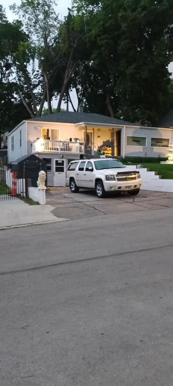 a car parked in a parking lot in front of a house at Private room in Omaha