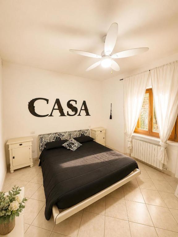 a bedroom with a bed with a csa sign on the wall at Casa Campomonte 2 in Poppi Stazione
