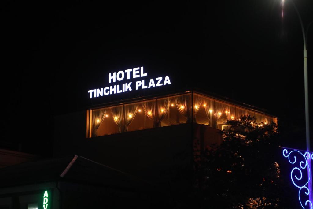 a sign on top of a building with lights at Tinchlik Plaza in Urganch