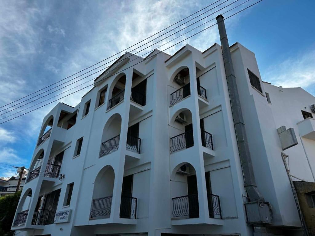 a white building with balconies on the side of it at Chariandry Court in Pissouri