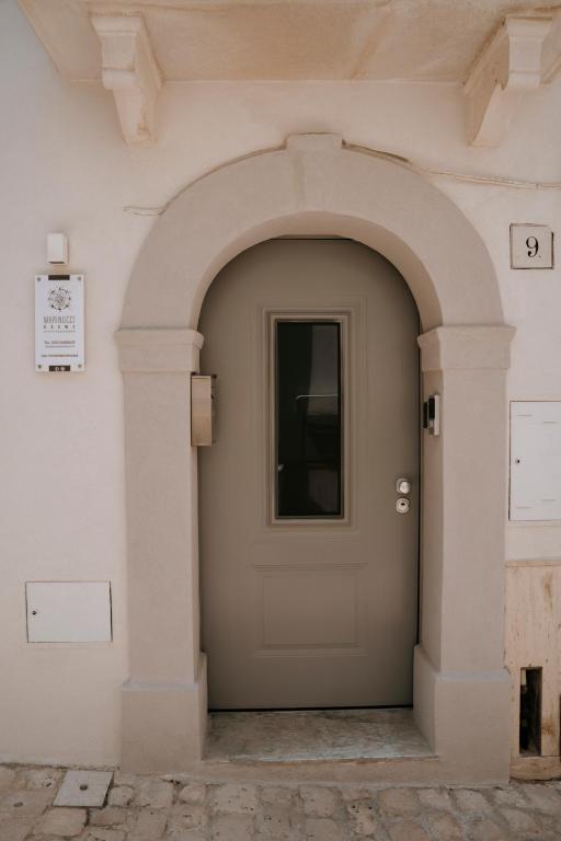 an entrance to a building with a gray door at Marinucci Rooms in Termoli