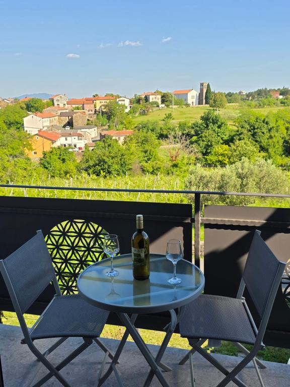 a table with two glasses of wine on a balcony at Mandala Terra in Gračišče