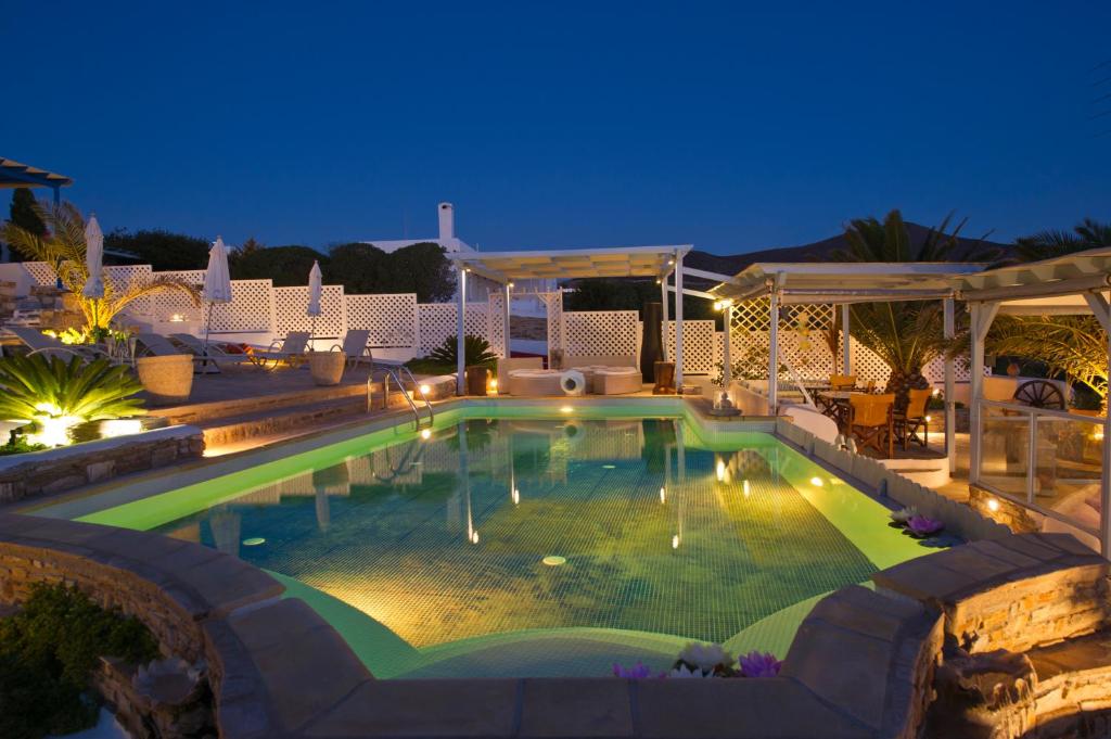 a swimming pool in a resort at night at Hotel Dolphin St Giorgio in Agios Georgios