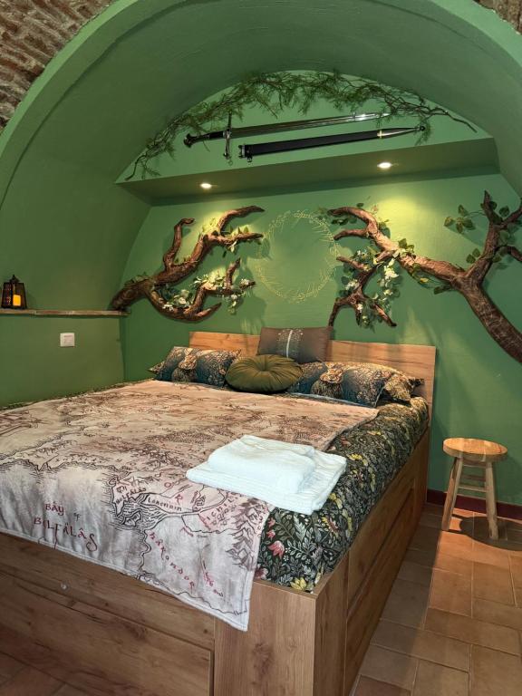 a bedroom with a bed with trees on the wall at Rifugio della Contea - Centro storico Perugia in Perugia