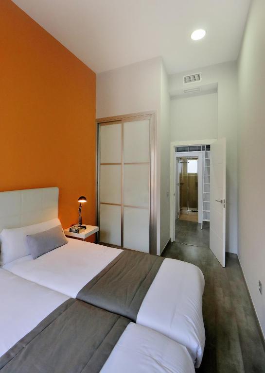 Posteľ alebo postele v izbe v ubytovaní Apartamentos Calle Larios