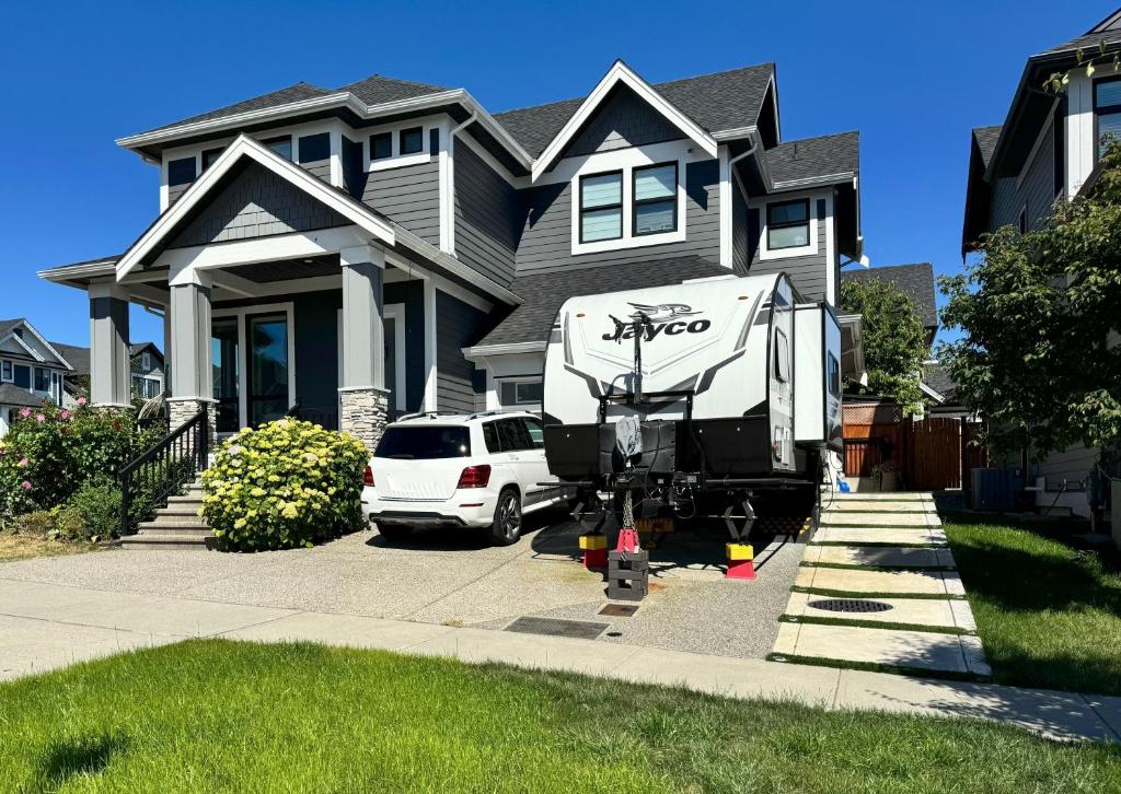 a large truck parked in front of a house at Cozy South Surrey Private Suite 1 Bedroom - 2 Beds - Separate Entrance in Surrey