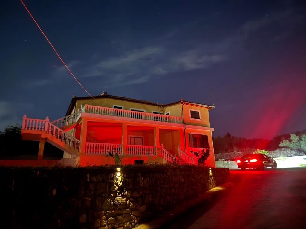 a house with red lights on the side of it at Solemar4 in Vlorë