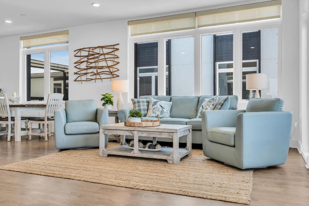 a living room with two blue chairs and a table at Professionally managed 1 block to beach Coffee in Seaside Heights