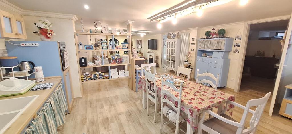 a kitchen with a table and chairs and a refrigerator at Alessandra‘s House in Arezzo