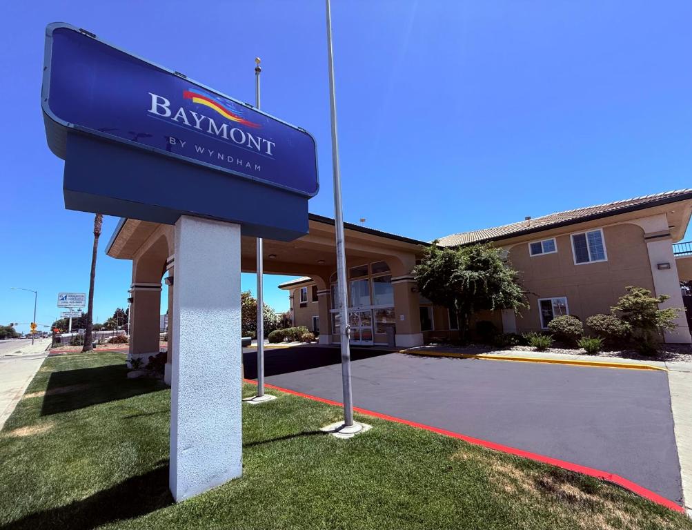 a sign for a hotel in front of a building at Baymont by Wyndham Manteca in Manteca