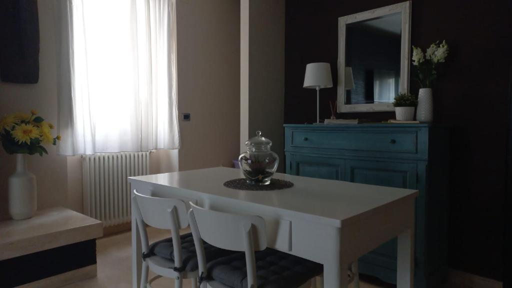a room with a table and chairs and a mirror at Corso Garibaldi in San Salvo