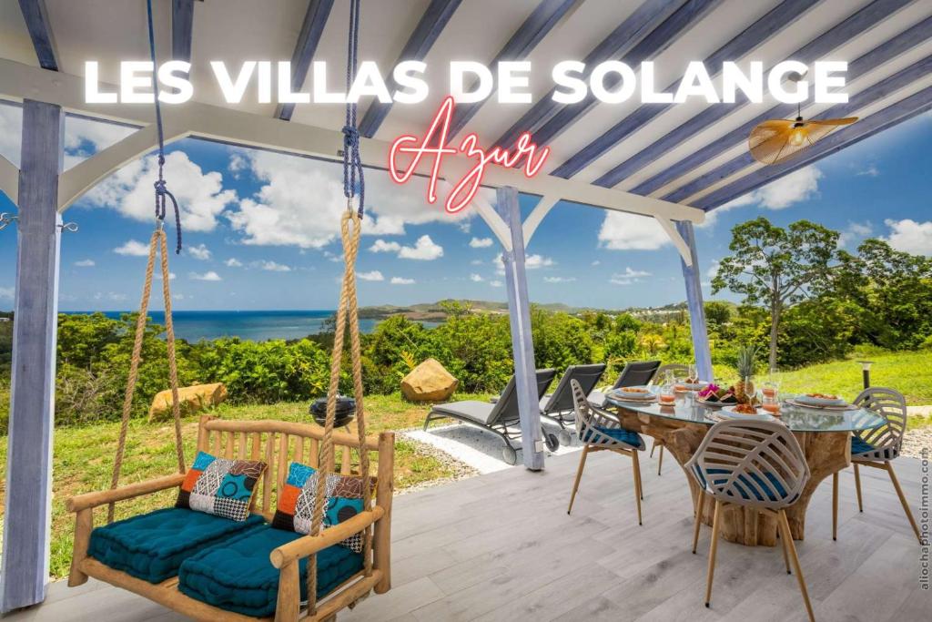 a swing on a patio with a table and chairs at La Villa de Solange - Azur in La Trinité