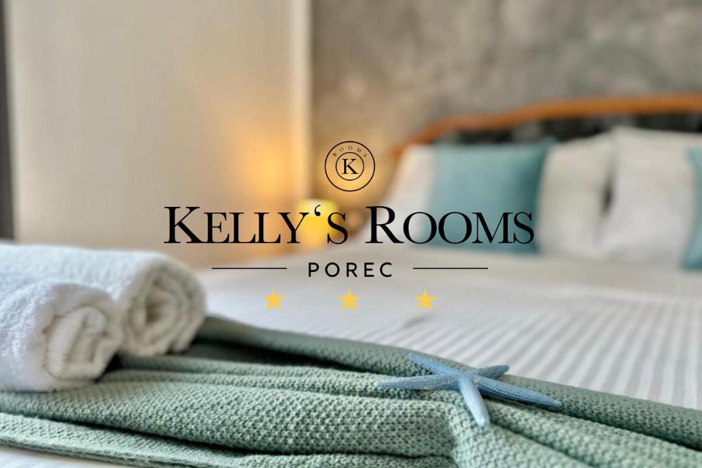 a pile of towels on a bed with a starfish at Kelly's Rooms in Poreč