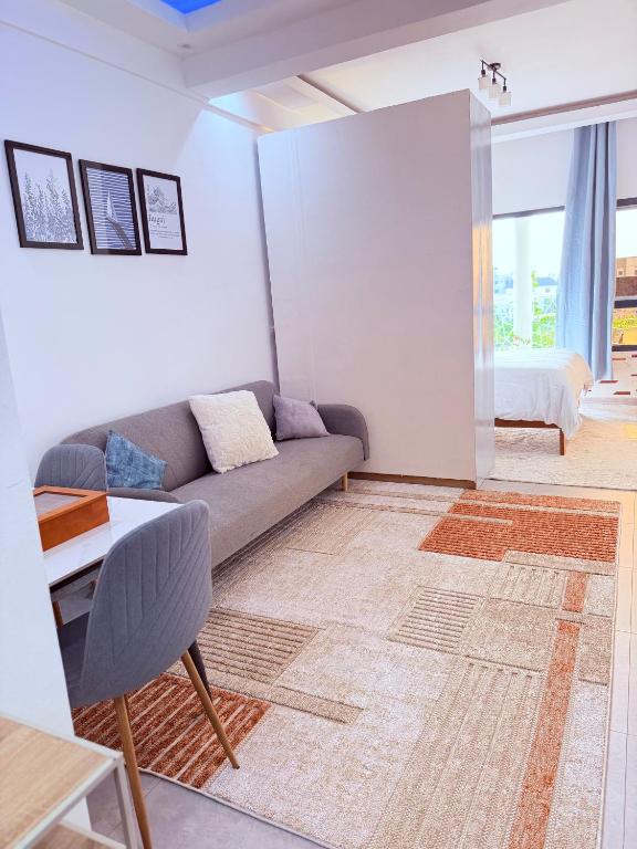 a living room with a couch and a table at Julianah appart in Douala