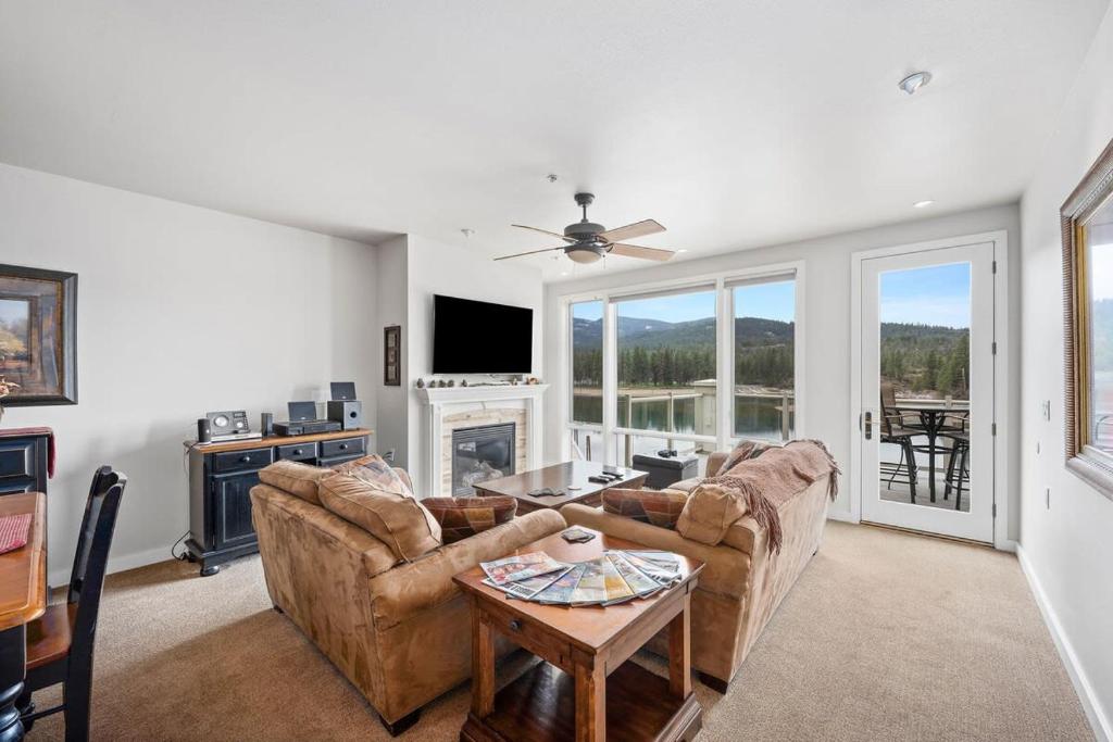 a living room with a couch and a table at Riverside Condo - Gorgeous Spokane River View in Post Falls