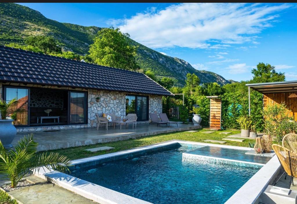 a swimming pool in the backyard of a house at The Stonehouse in Ulcinj